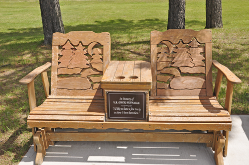 carved swinging bench